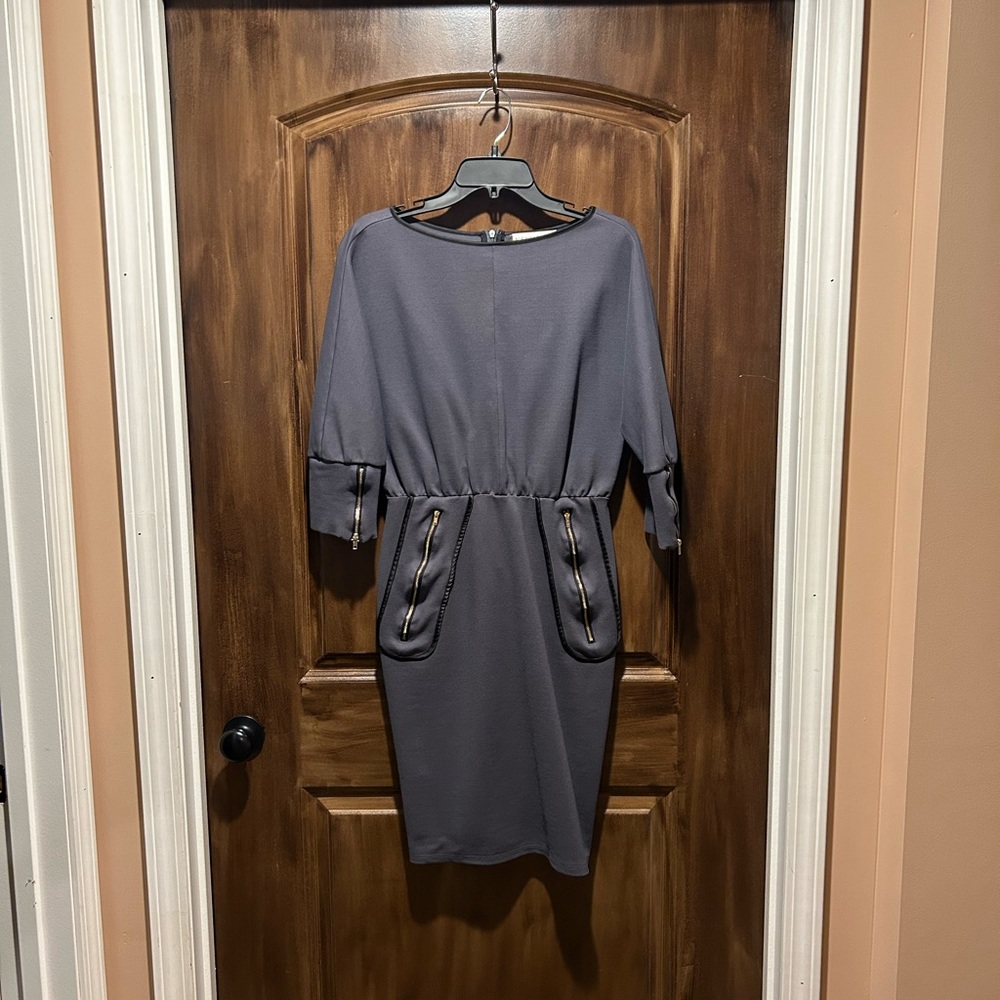 Charcoal grey dress with black piping and zipper detail.